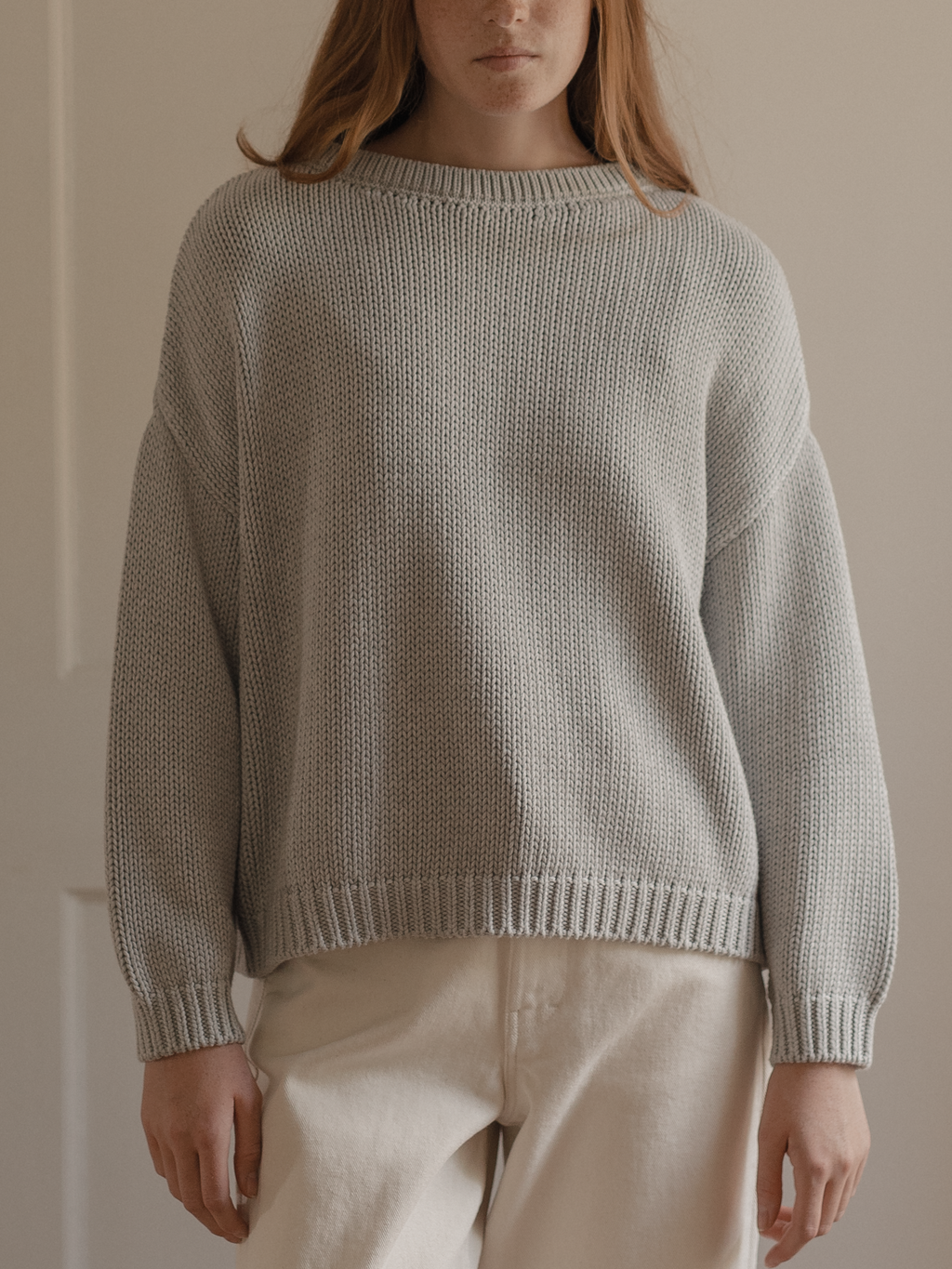Model wearing the Townes Pullover in Pebble by Gillian Stevens, front view showing chunky knit texture