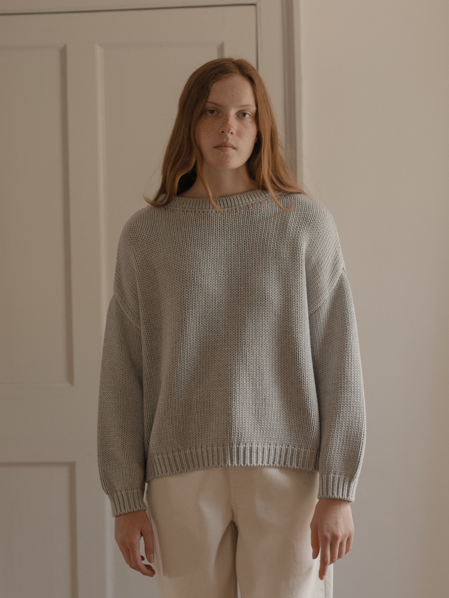 Model wearing the Townes Pullover in Pebble by Gillian Stevens, front view showing chunky knit texture