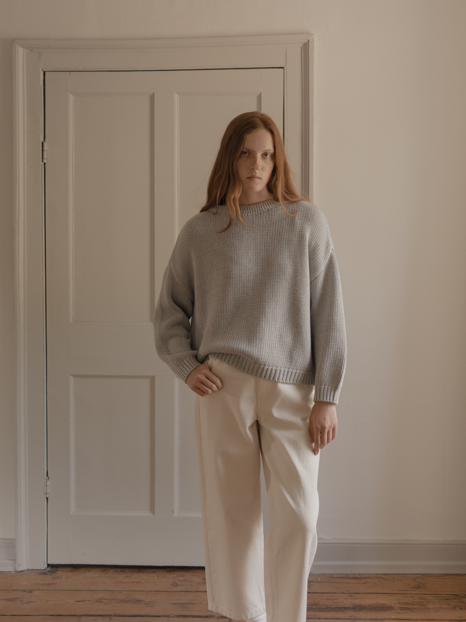 Model wearing the Townes Pullover in Pebble by Gillian Stevens, front view showing chunky rib knit texture