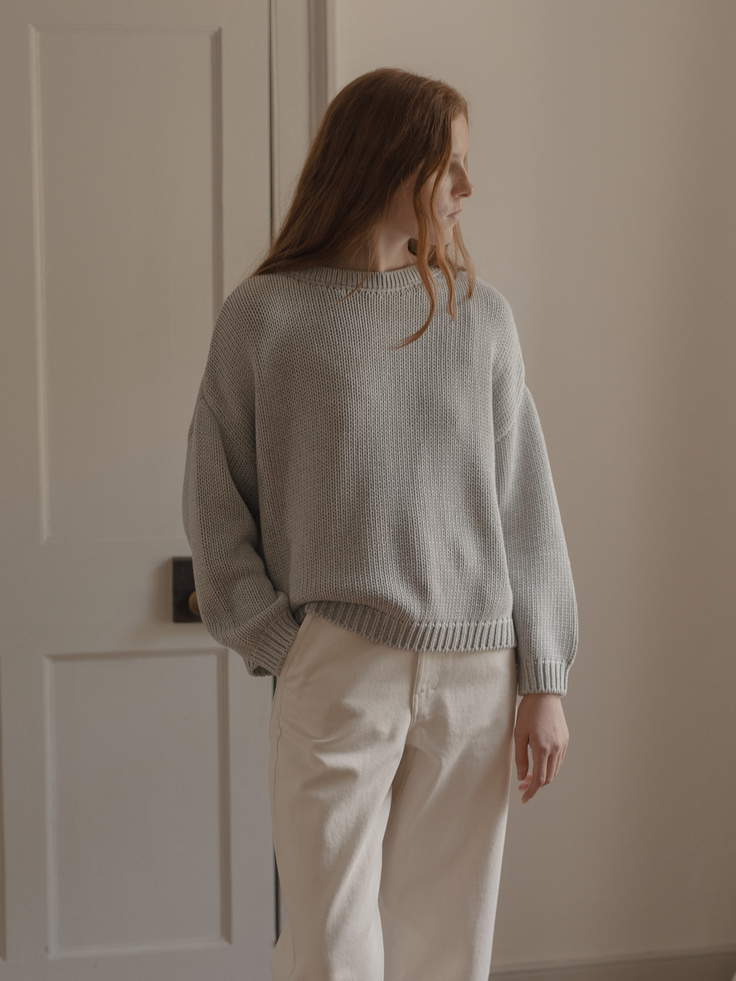 Model wearing the Townes Pullover in Pebble by Gillian Stevens, back view showing chunky rib knit
