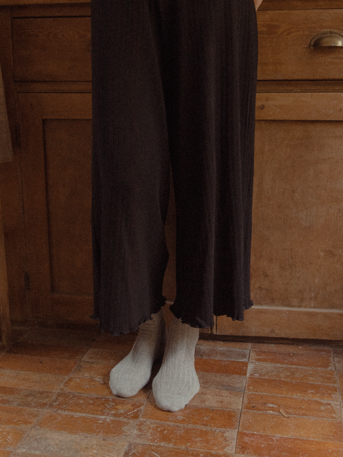 Close-up of the Calla Pant in Noir by Gillian Stevens, showing frill hem detail at ankle