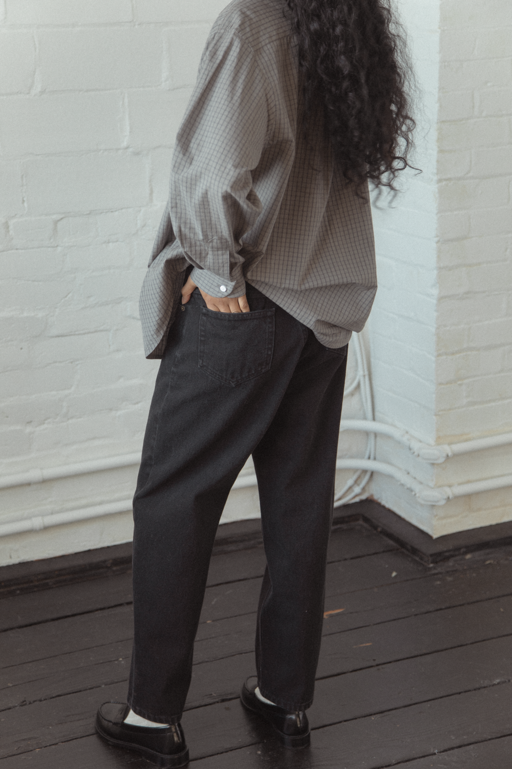 Model wearing the Dara Jean in Noir by Gillian Stevens, back view showing pocket detail