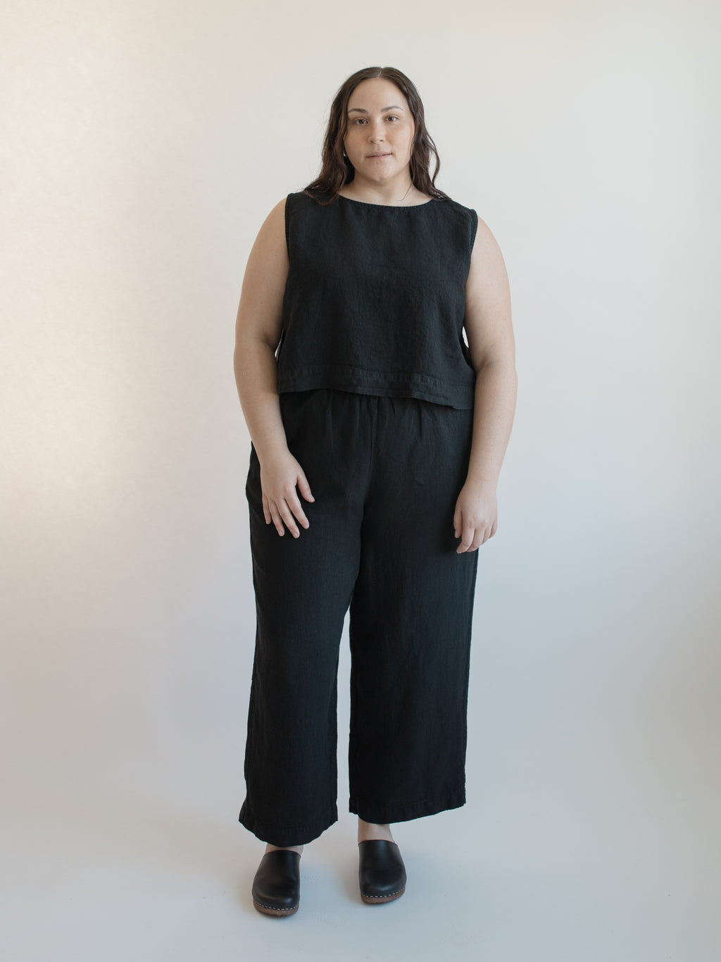 Model wearing the Finley Top in Noir by Gillian Stevens, front view styled with wide-leg trousers, view 2