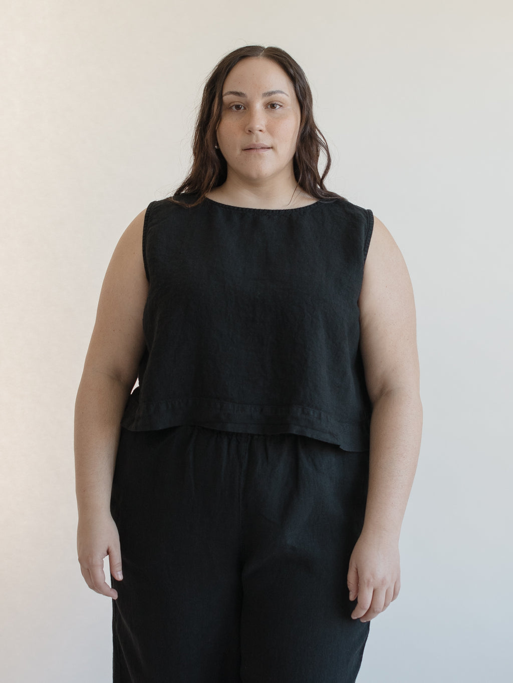 Model wearing the Finley Top in Noir by Gillian Stevens, front view showing cropped silhouette