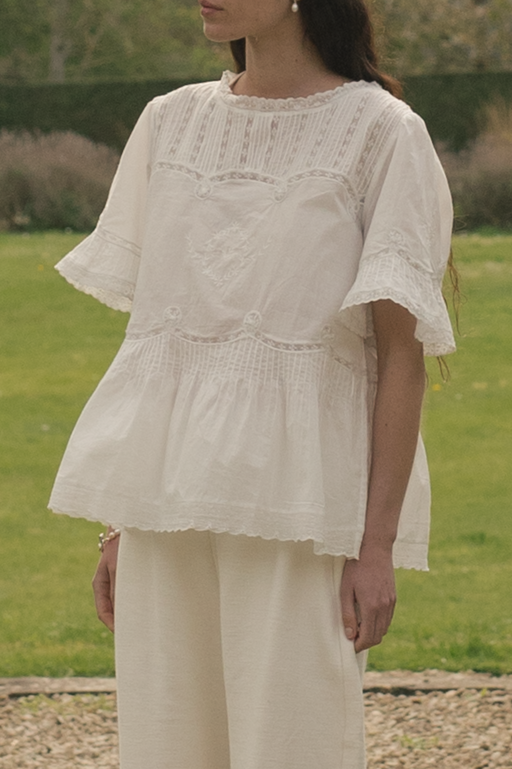 Model wearing the Astrid Blouse in Salt by Gillian Stevens, front view showing lace and pintuck detail