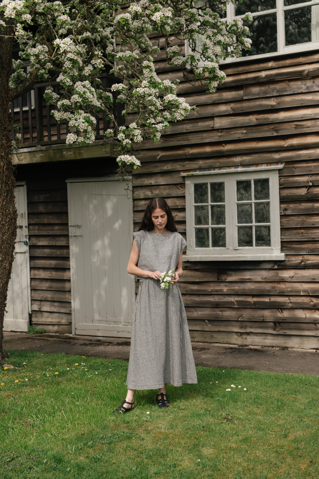 Model wearing the Frances Skirt in Gingham Noir by Gillian Stevens, outdoor full-length view