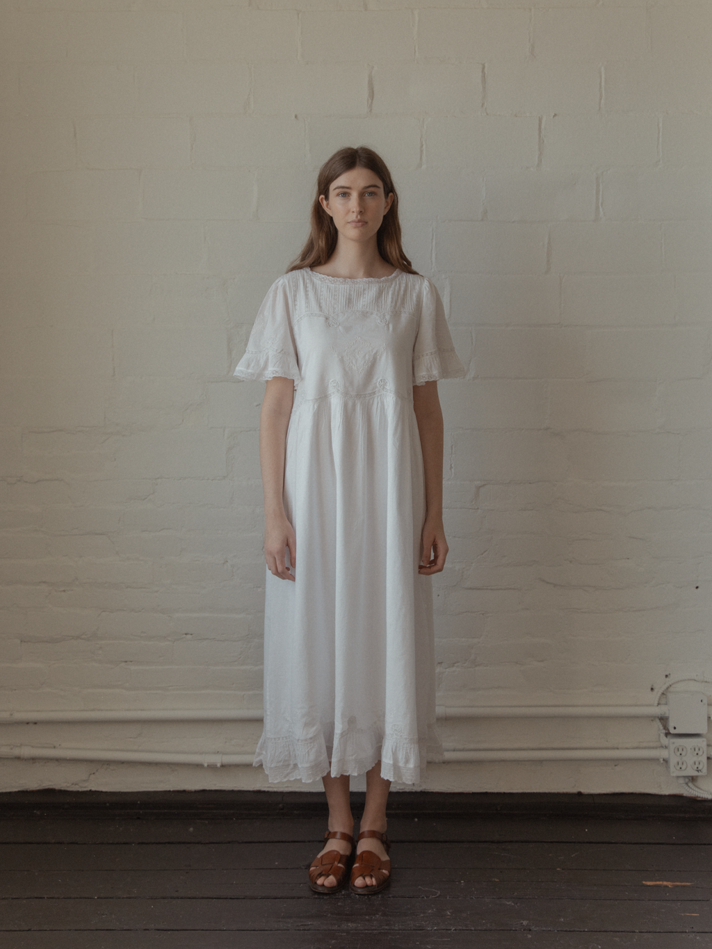 Model wearing the Astrid Dress in Salt by Gillian Stevens, full-length front view with lace trim detail