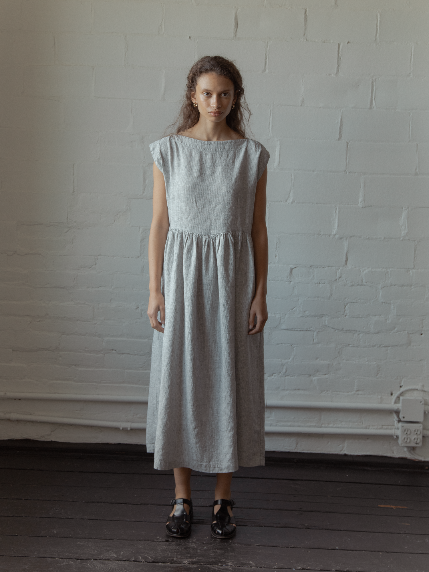 Model wearing the Valley Dress in Charcoal Stripe by Gillian Stevens, front view full length