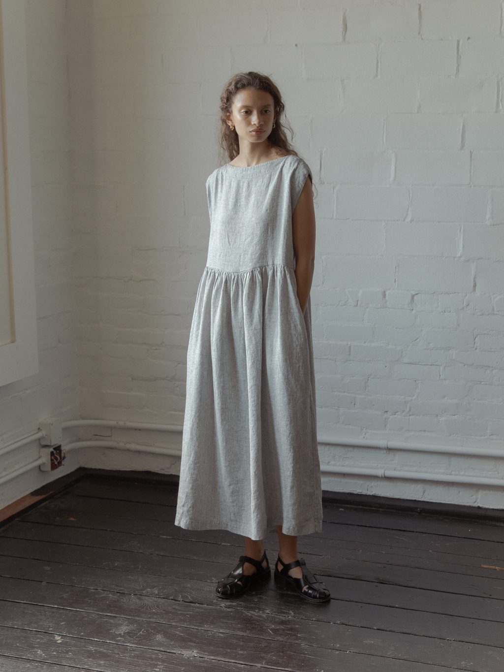 Model wearing the Valley Dress in Charcoal Stripe by Gillian Stevens, full-length front view