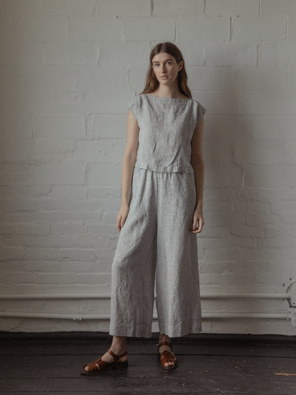 Model wearing the Valley Top in Charcoal Stripe by Gillian Stevens, full-length front view styled with wide-leg linen pants