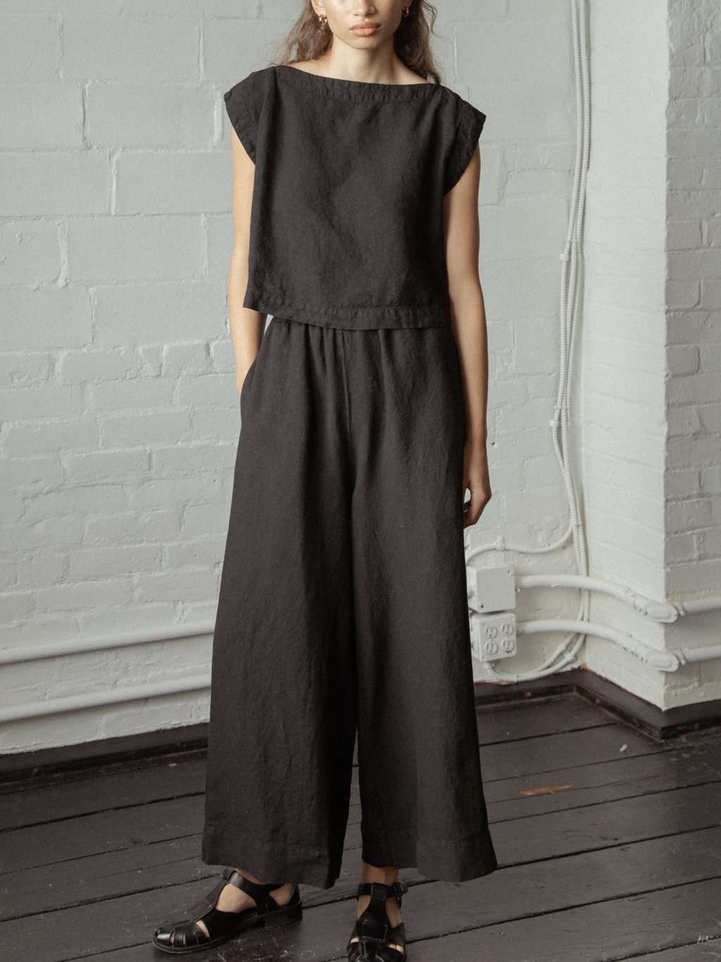 Model wearing the Ines Pant in Noir by Gillian Stevens, front view showing wide leg and elasticated waist