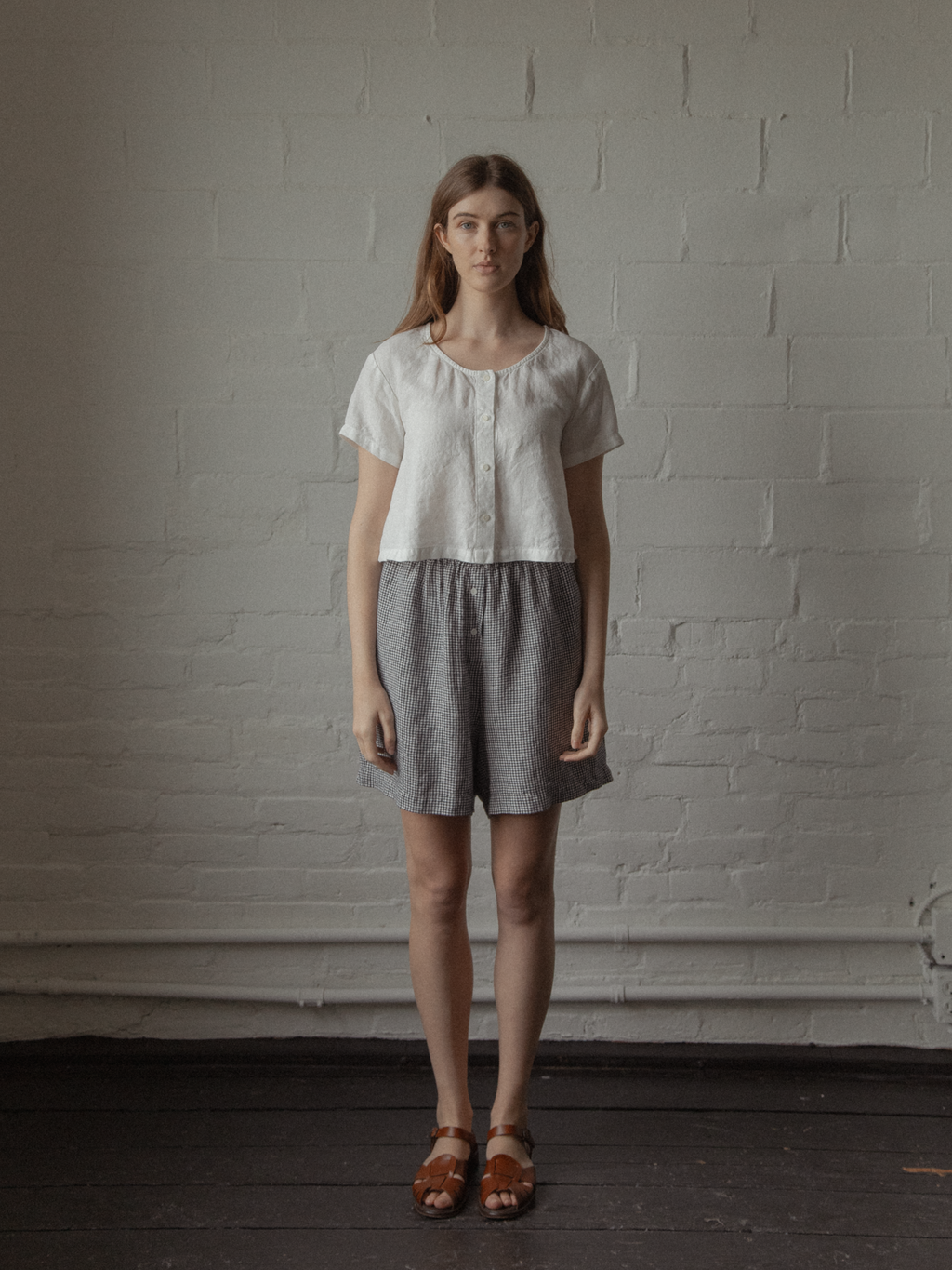 Model wearing the Wren Top in Salt by Gillian Stevens, full-length front view styled with gingham shorts