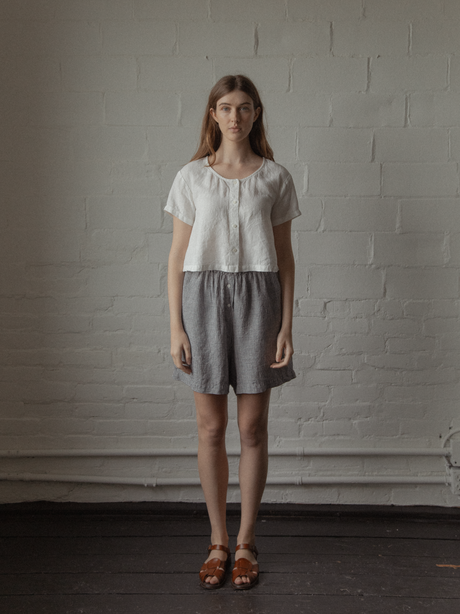 Model wearing the Wren Top in Salt by Gillian Stevens, full-length front view styled with gingham shorts