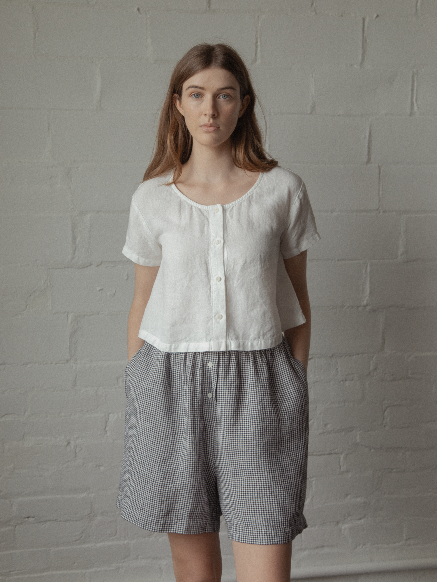 Model wearing the Wren Top in Salt by Gillian Stevens, front view styled with gingham shorts