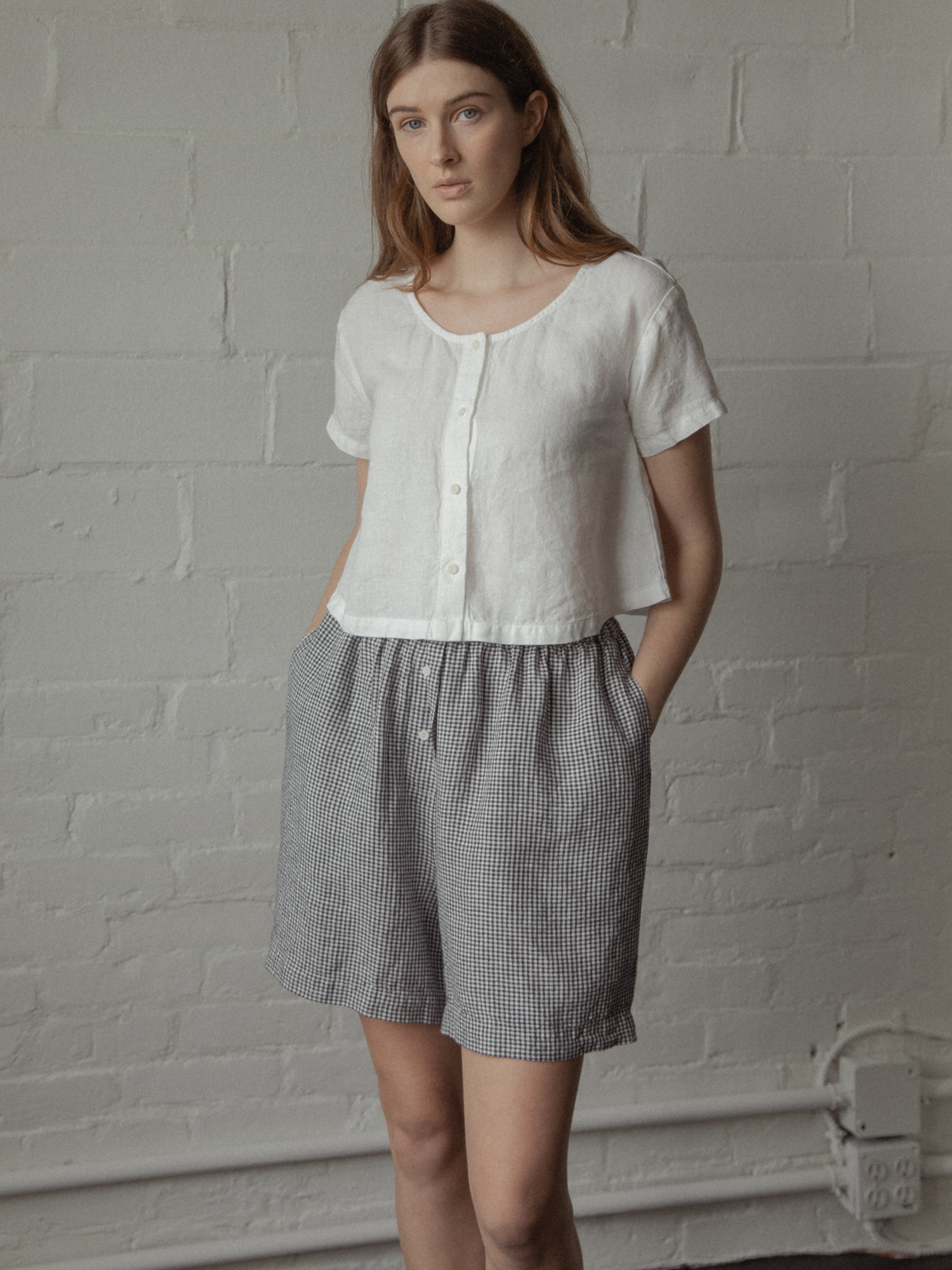Model wearing the Wren Top in Salt by Gillian Stevens, front view styled with gingham shorts