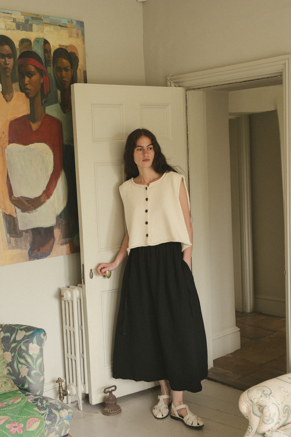 Model wearing the Lennon Vest in Ivory by Gillian Stevens, full-length front view in styled interior setting