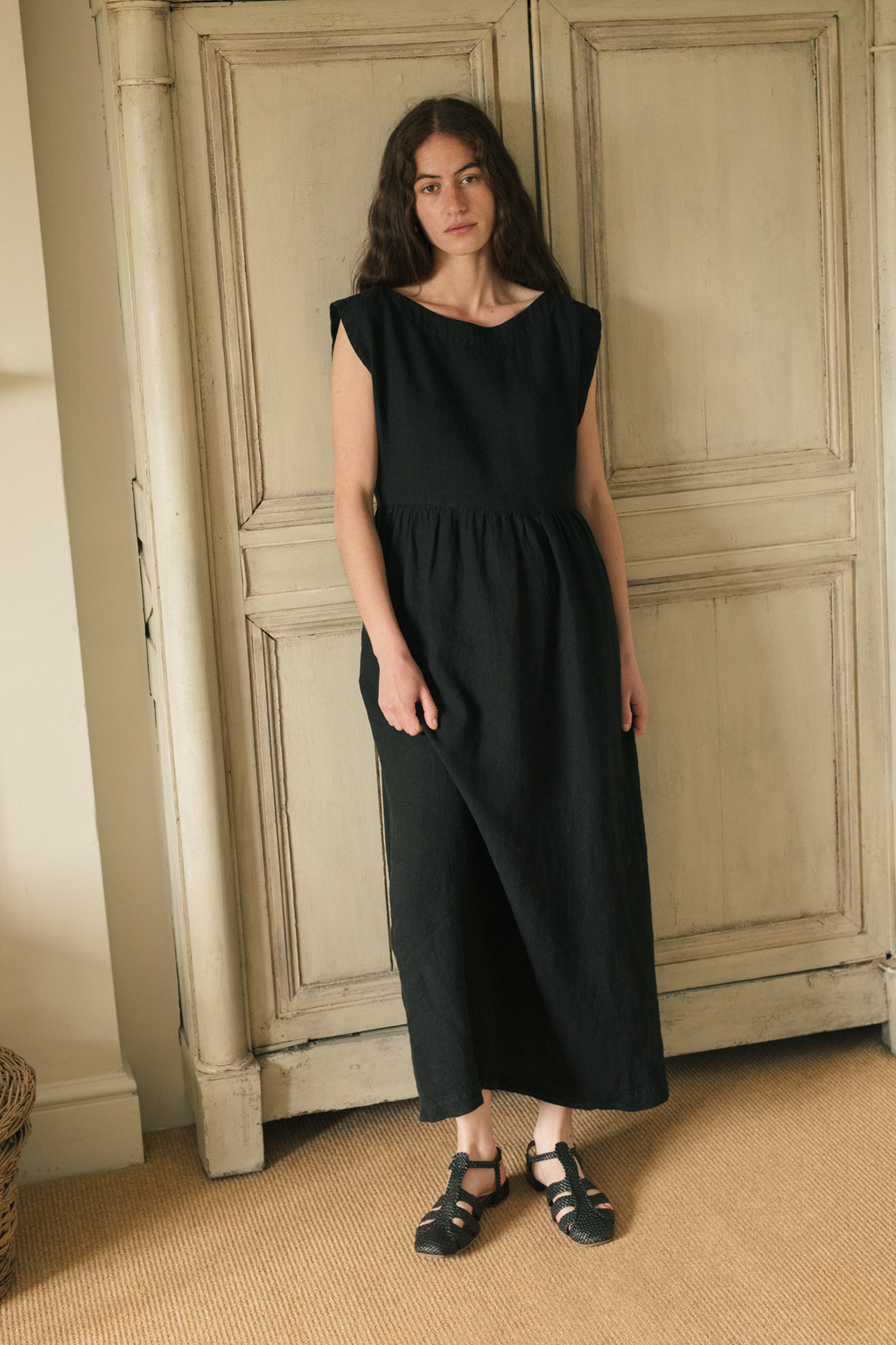 Model wearing the Valley Dress in Noir by Gillian Stevens, front view showing gathered waist