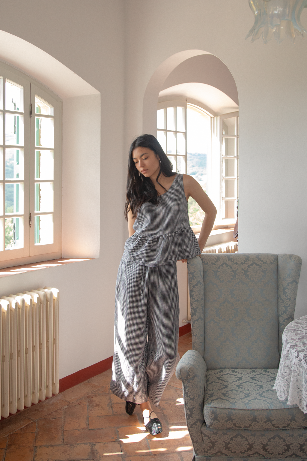 Model wearing the Olive Pant in Marine Gingham by Gillian Stevens, full-length front view in a sunlit room