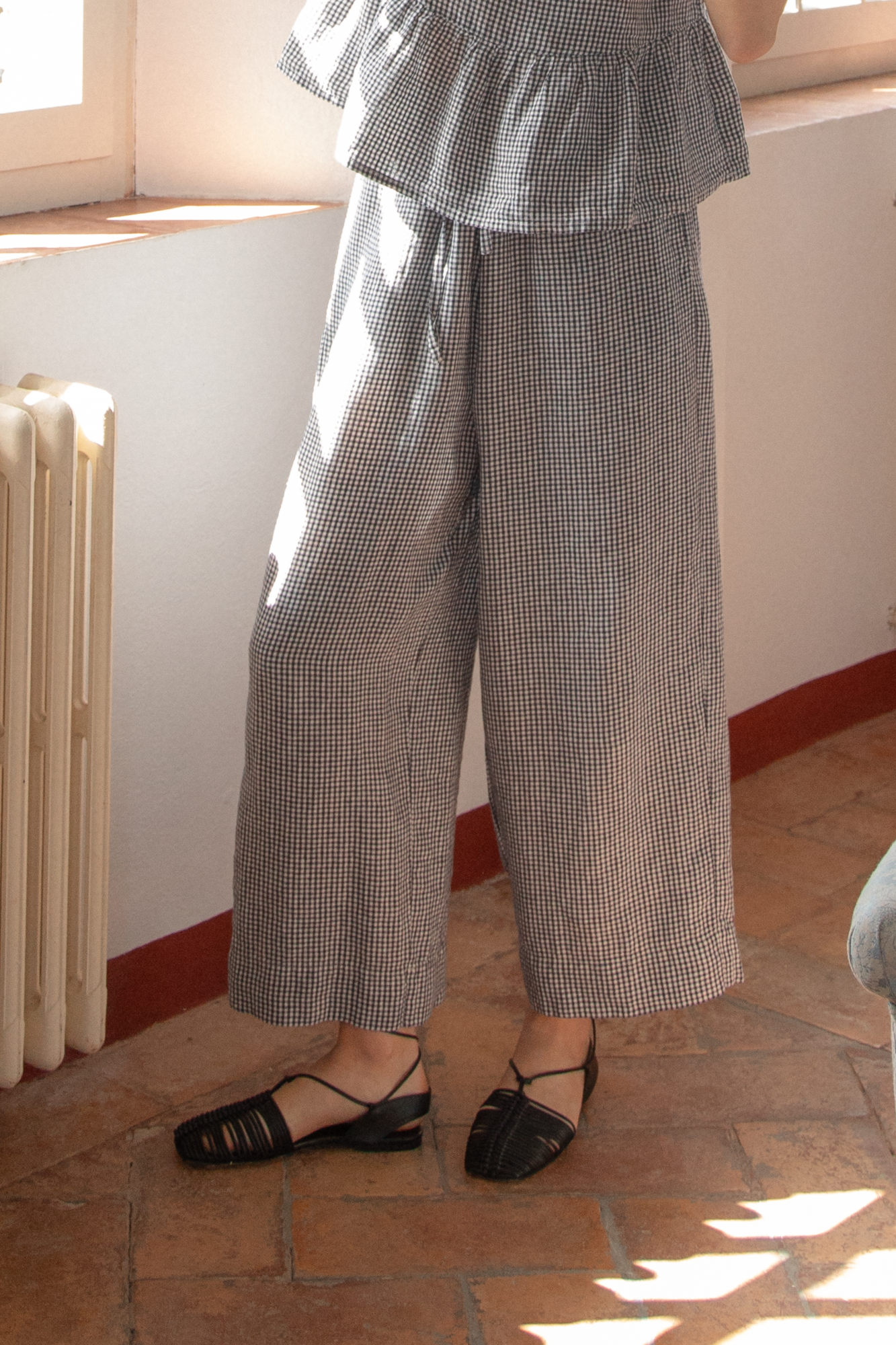 Model wearing the Olive Pant in Marine Gingham by Gillian Stevens, front view showing wide cropped leg