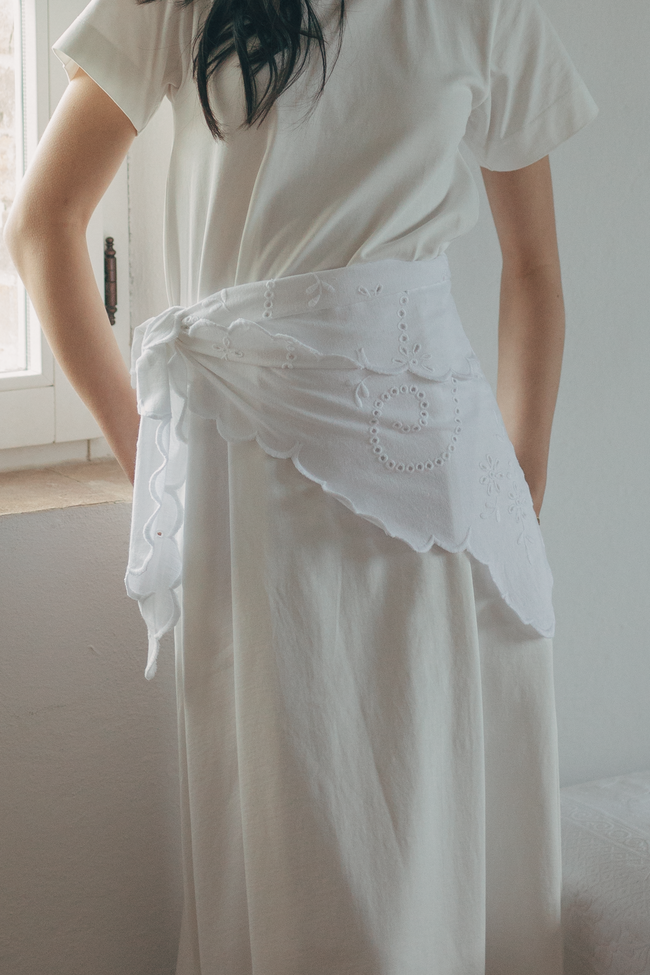 Model wearing the Matilde Scarf in Salt by Gillian Stevens, tied at the waist showing broderie detail