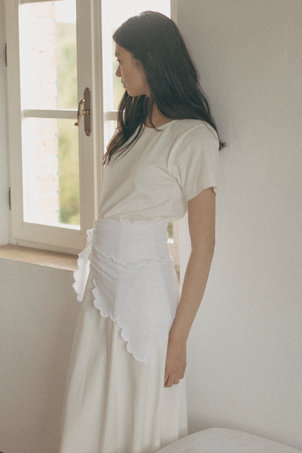 Model wearing the Matilde Scarf in Salt by Gillian Stevens, side view styled as a wrap at the waist