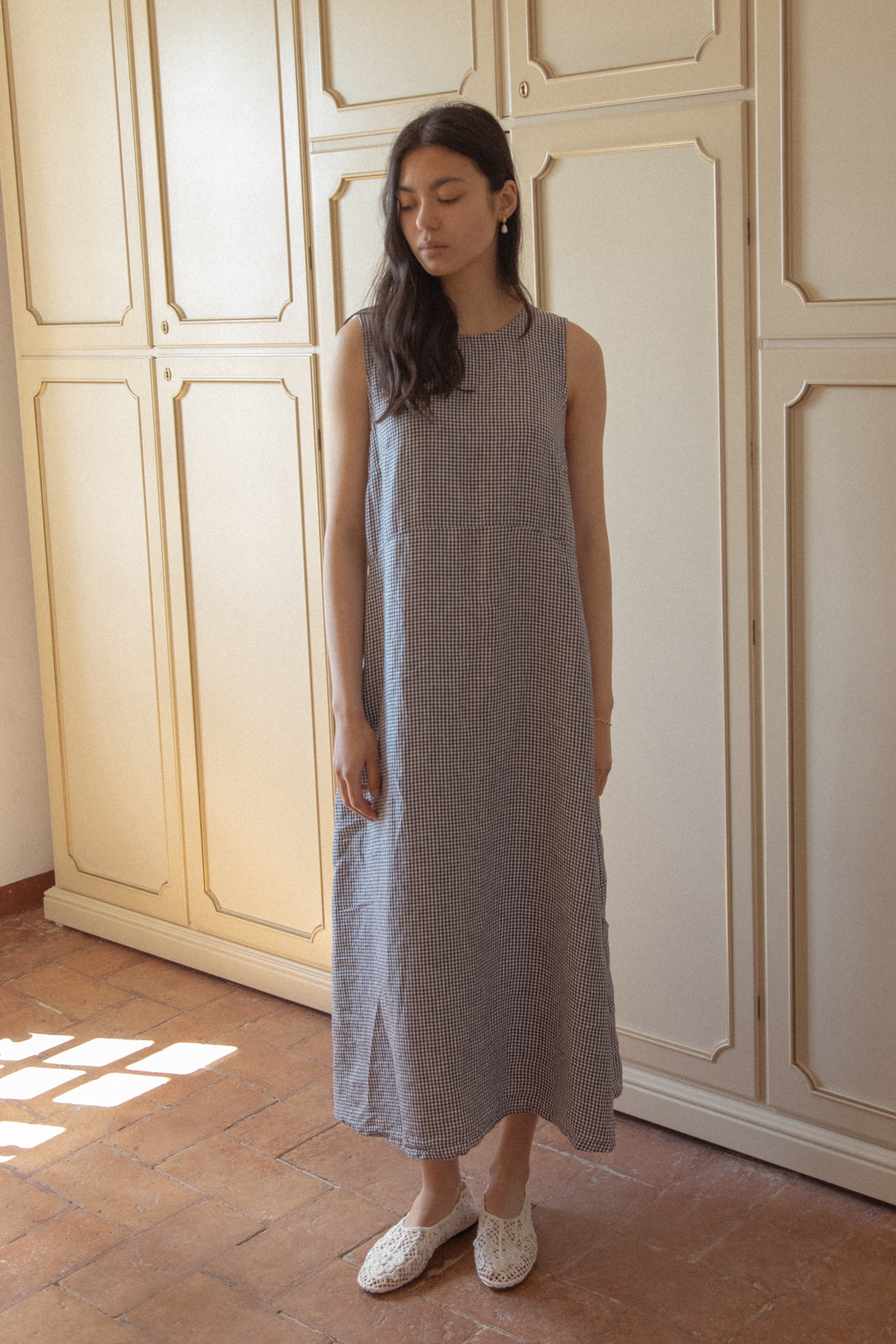 Model wearing the Paige Dress in Marine Gingham by Gillian Stevens, front view showing midi length and side slit