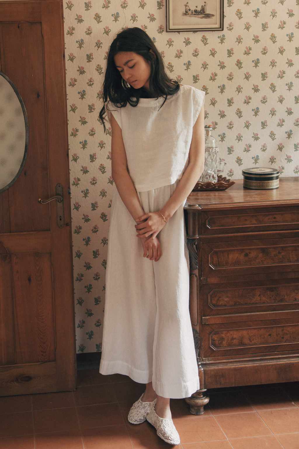 Model wearing the Ines Pant in Salt by Gillian Stevens, styled with a cropped top in a vintage room setting