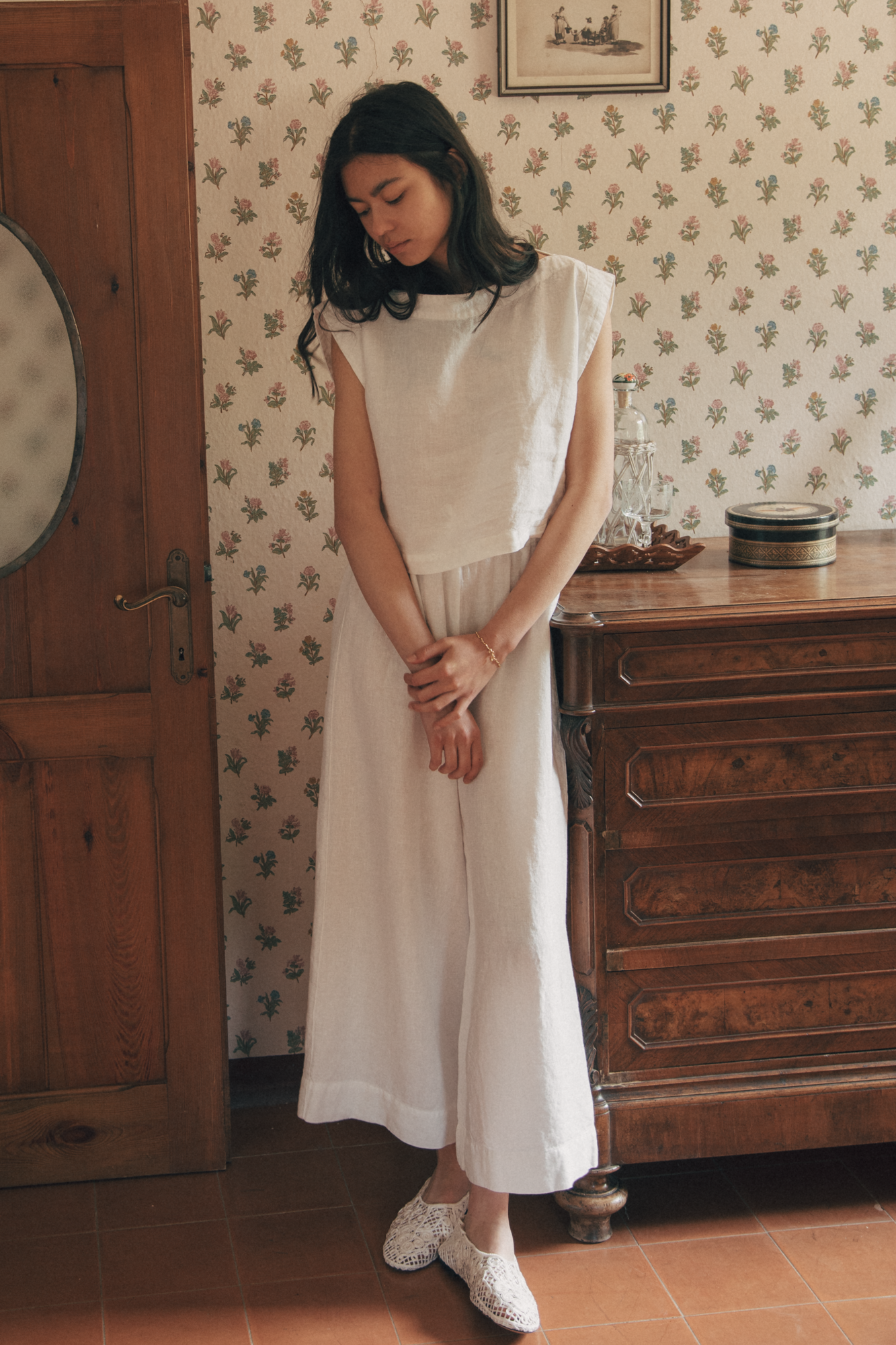 Model wearing the Ines Pant in Salt by Gillian Stevens, styled with a cropped top in a vintage room setting
