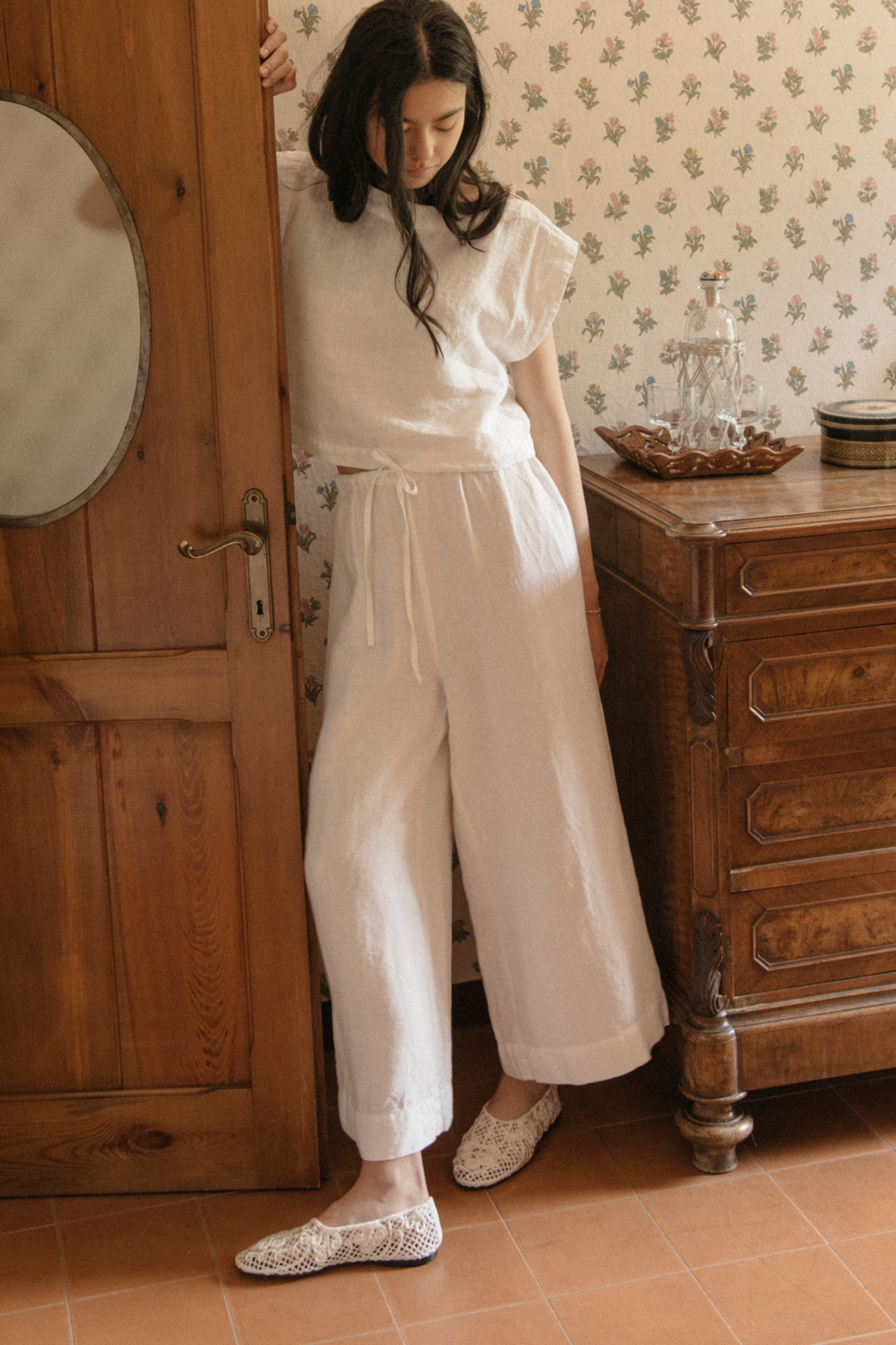 Model wearing the Ines Pant in Salt by Gillian Stevens, full-length front view in a vintage-styled room