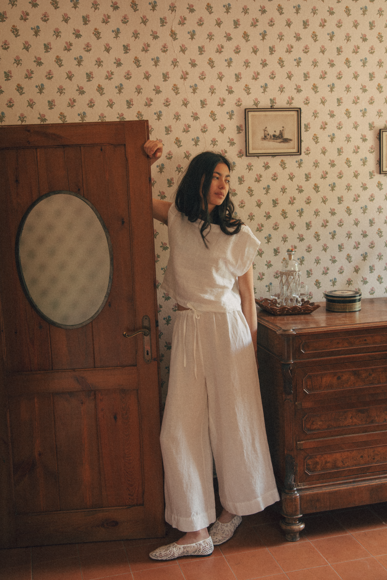 Model wearing the Ines Pant in Salt by Gillian Stevens, full-length front view in a vintage room