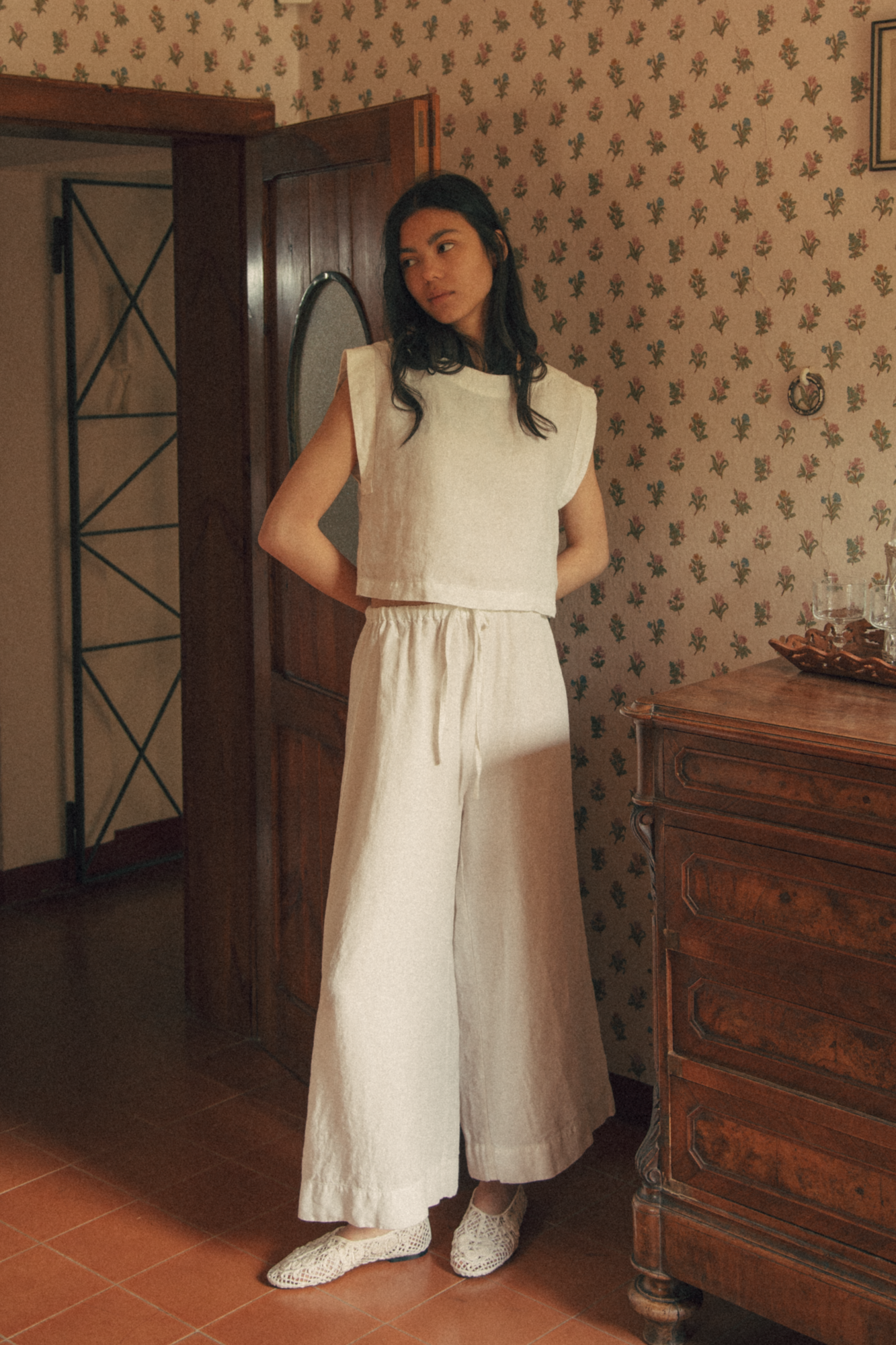 Model wearing the Ines Pant in Salt by Gillian Stevens, full-length front view in a vintage room setting
