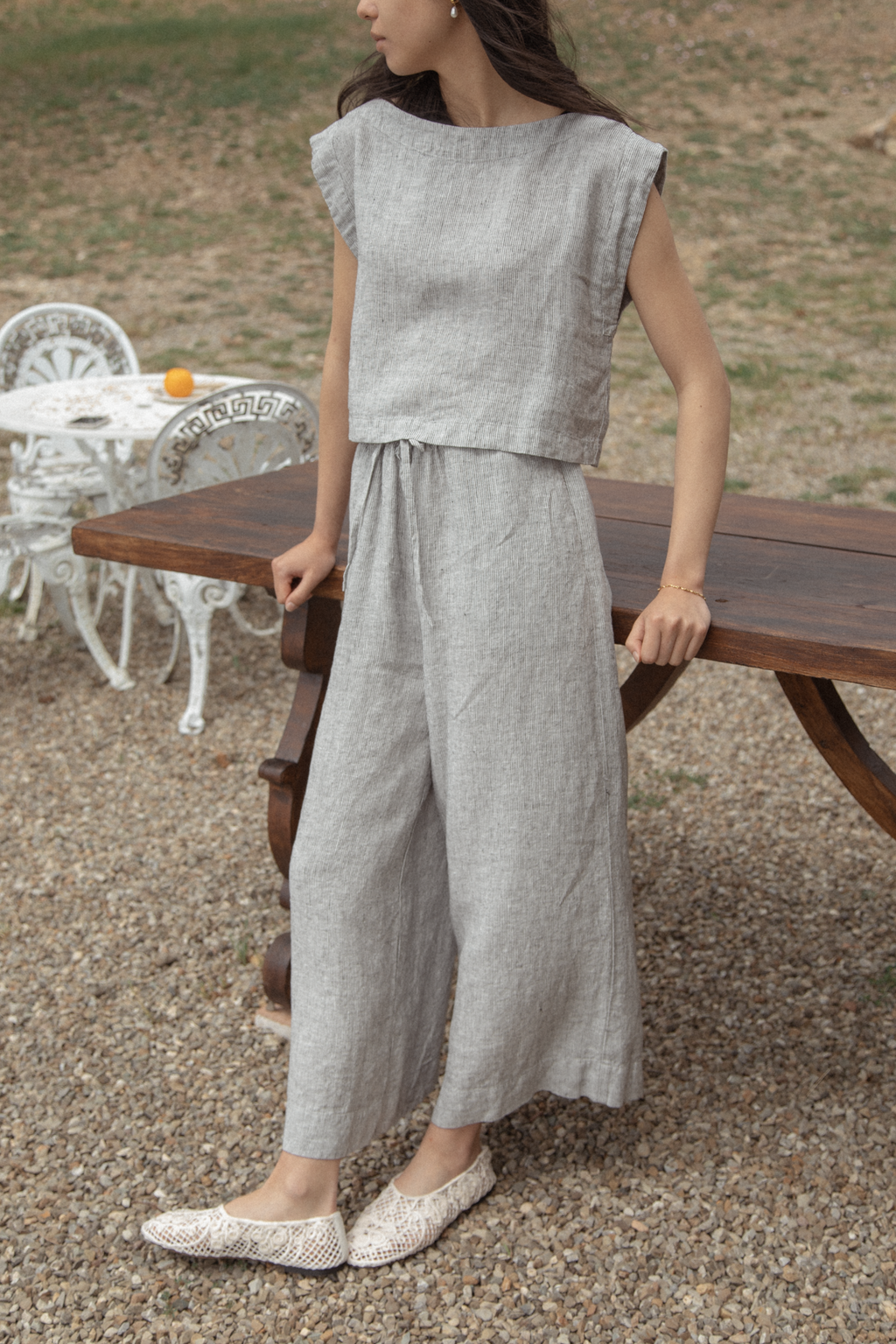Model wearing the Ines Pant in Charcoal Stripe by Gillian Stevens, front view styled with matching top outdoors