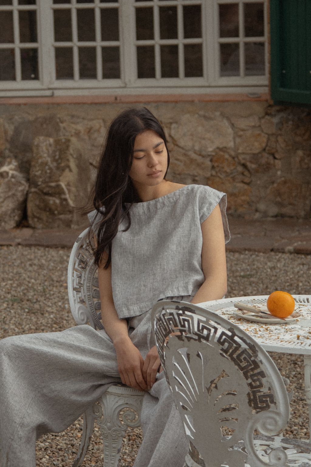 Model seated outdoors wearing the Valley Top in Charcoal Stripe by Gillian Stevens, front view
