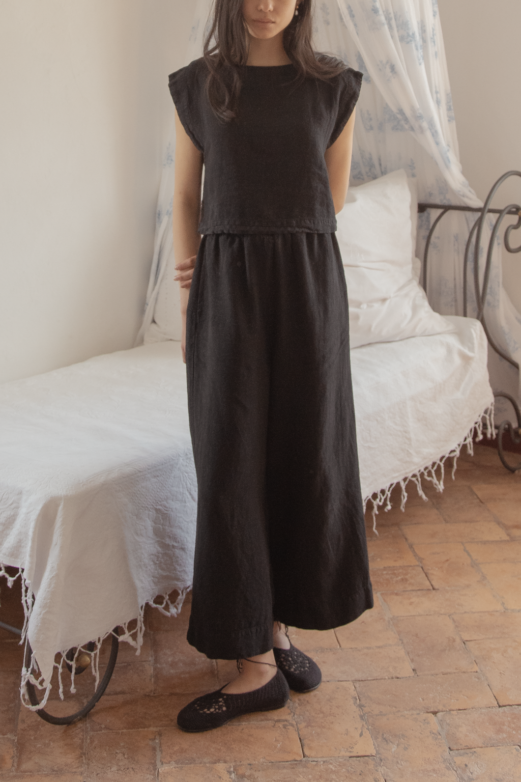 Model wearing the Ines Pant in Noir by Gillian Stevens, full-length front view styled with a matching top