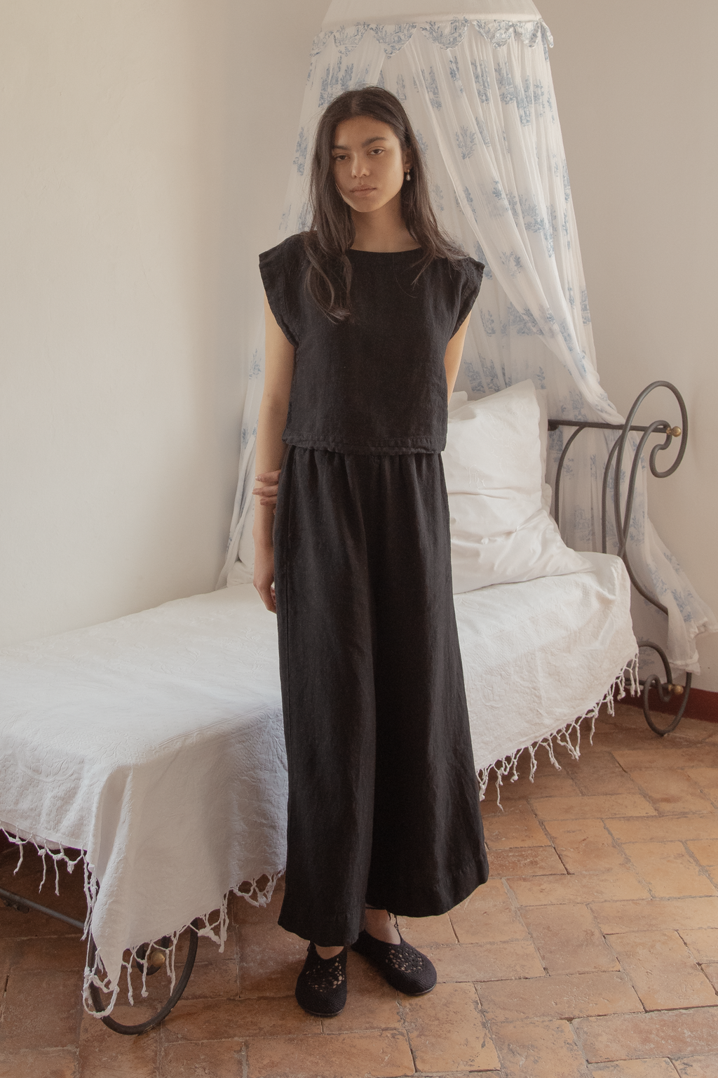 Model wearing the Ines Pant in Noir by Gillian Stevens, full-length front view styled with a matching top