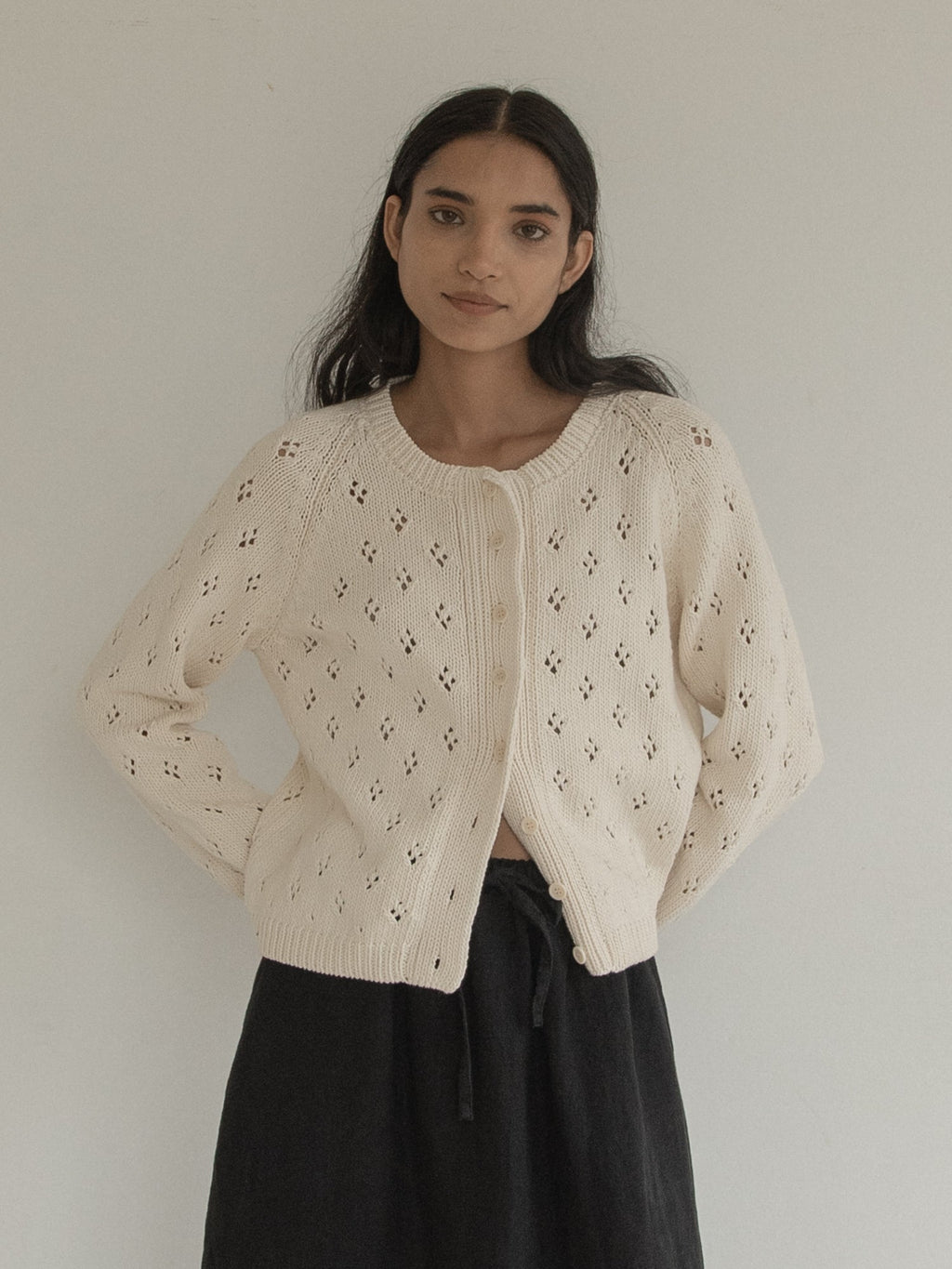 Model wearing the Mabel Cardigan in Ivory by Gillian Stevens, front view showing pointelle knit detail