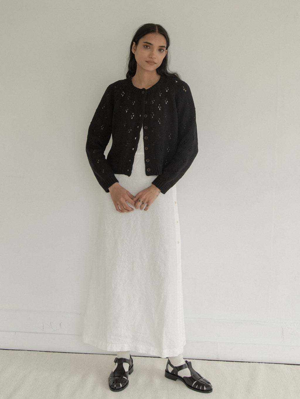 Model wearing the Mabel Cardigan in Noir by Gillian Stevens, full-length front view