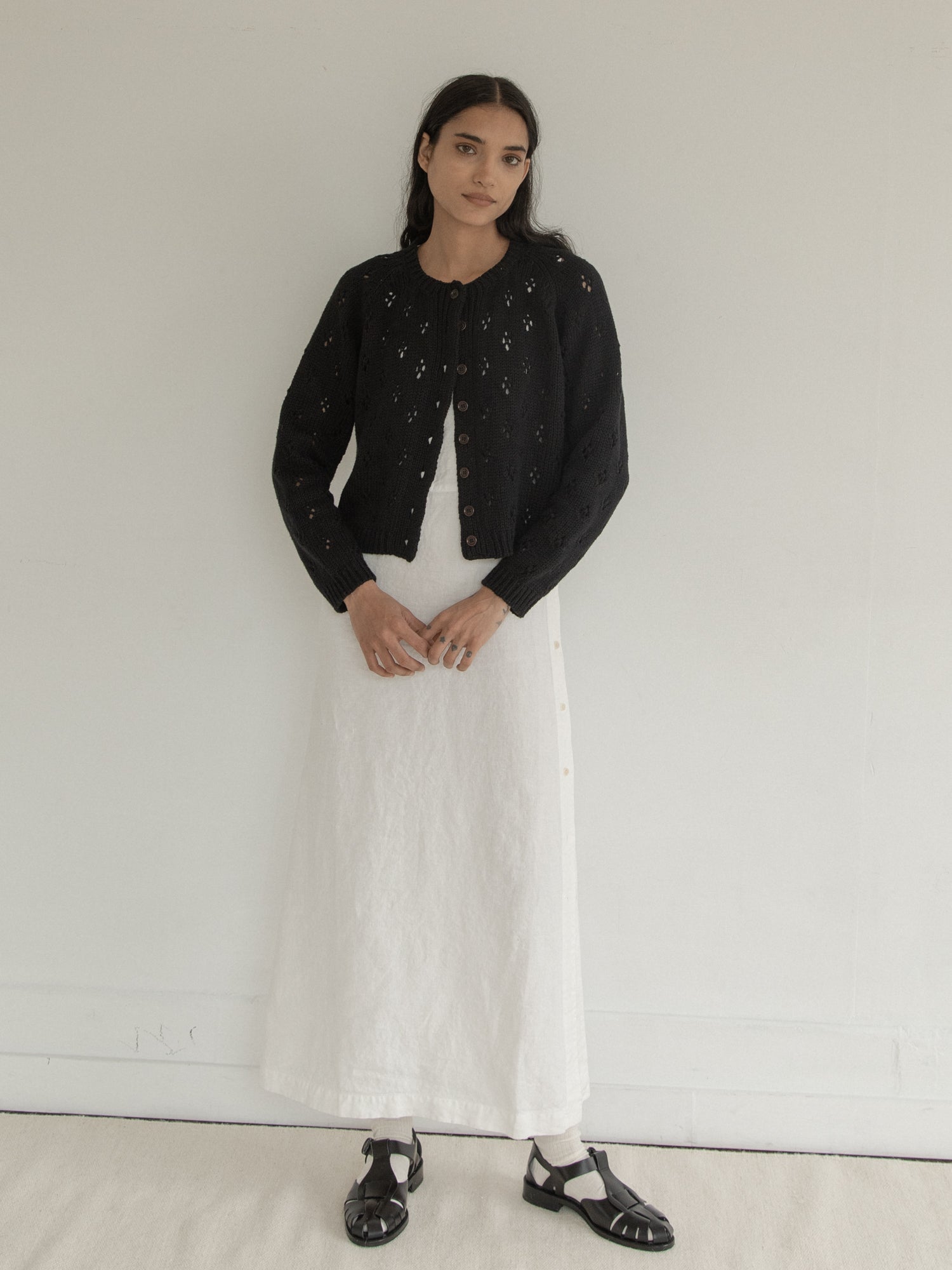 Model wearing the Mabel Cardigan in Noir by Gillian Stevens, full-length front view