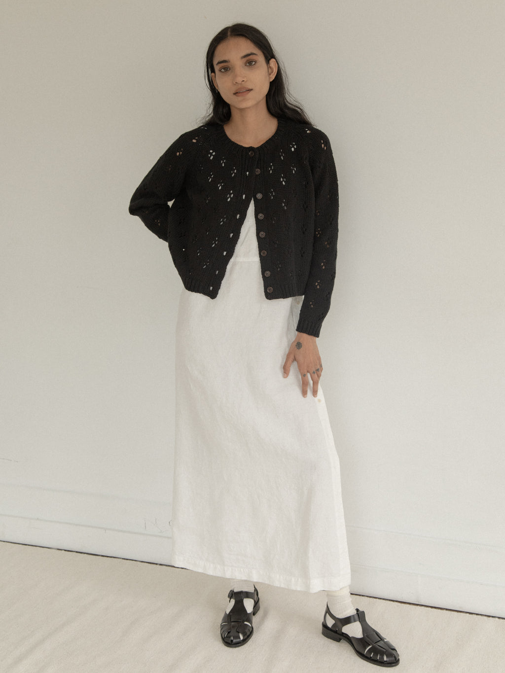 Model wearing the Mabel Cardigan in Noir by Gillian Stevens, full-length front view, view 2