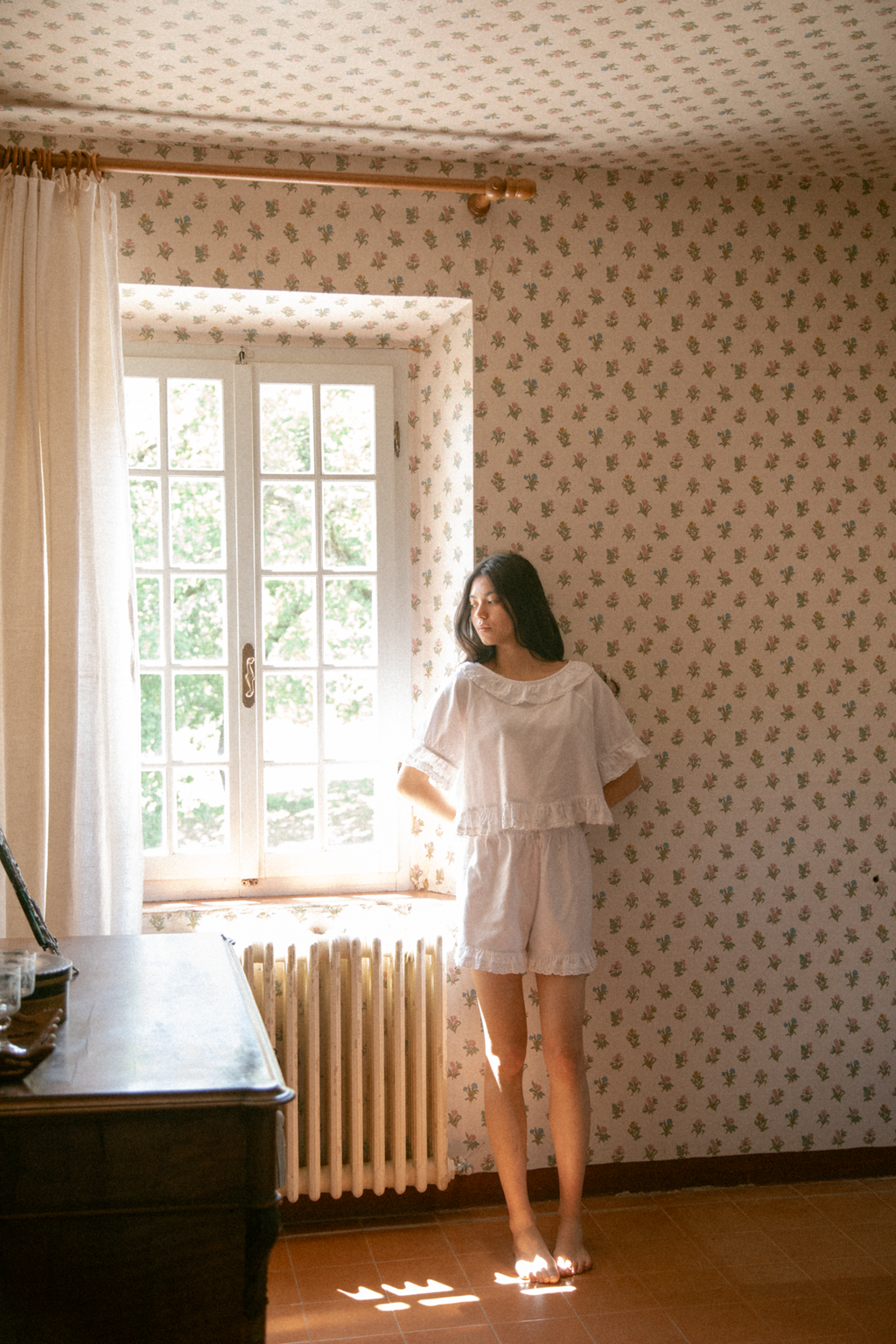 Model wearing the Arlette Short in Salt by Gillian Stevens, styled with matching top in a sunlit vintage room
