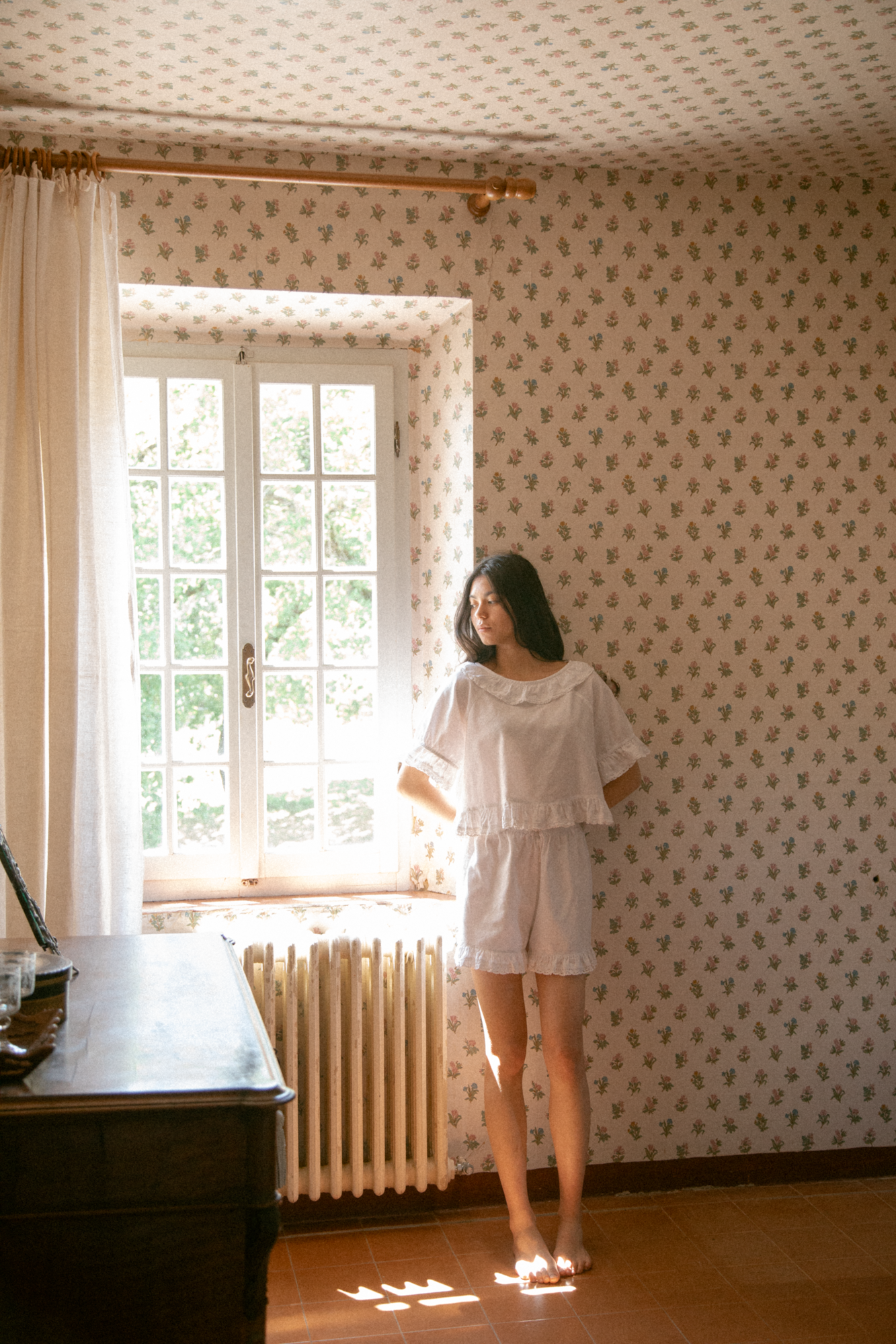 Model wearing the Arlette Short in Salt by Gillian Stevens, styled with matching top in a sunlit vintage room