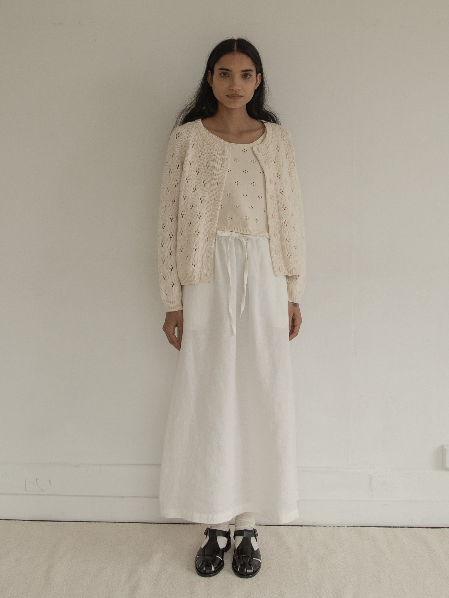 Model wearing the Mabel Cardigan in Ivory by Gillian Stevens, front view showing pointelle detail, view 2