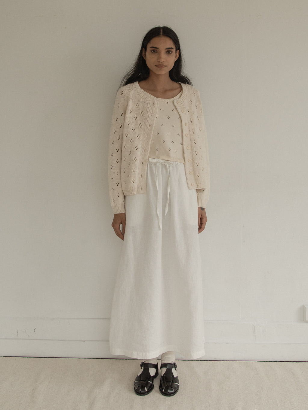 Model wearing the Mabel Cardigan in Ivory by Gillian Stevens, front view showing pointelle detail, view 3