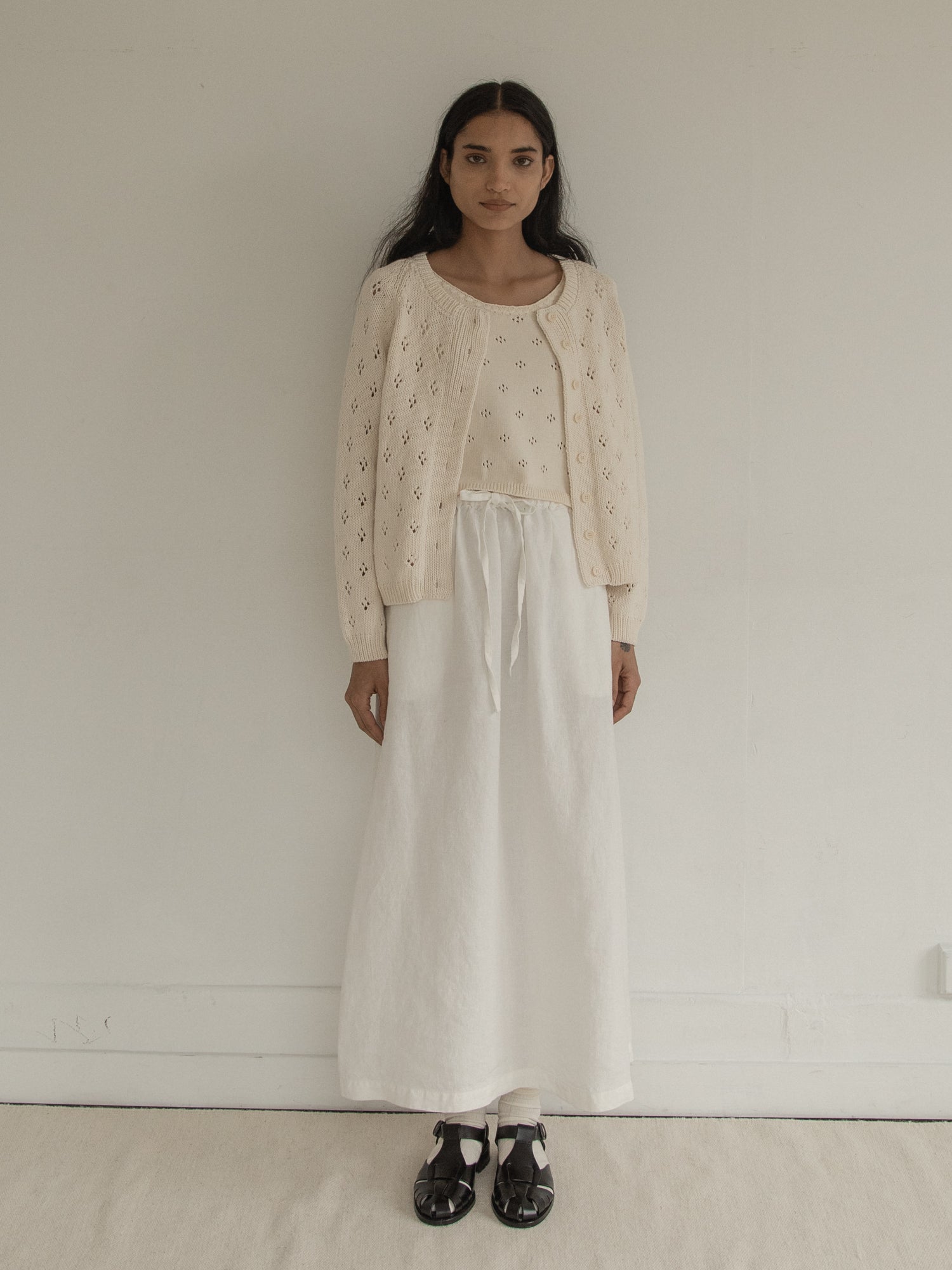 Model wearing the Mabel Cardigan in Ivory by Gillian Stevens, front view showing pointelle detail, view 3