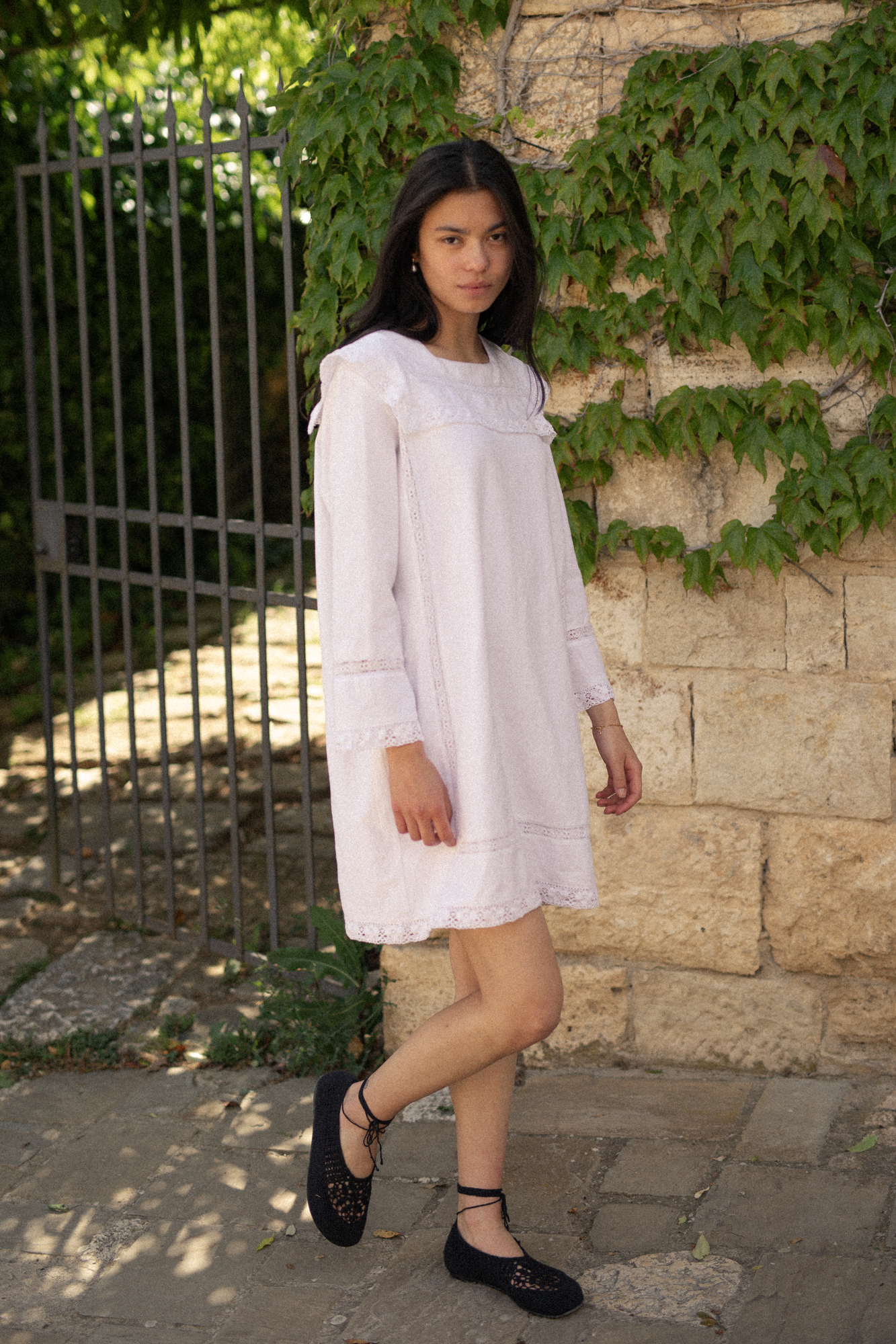 Model wearing the Laine Dress in Salt by Gillian Stevens, front view with lace trim detail and long sleeves