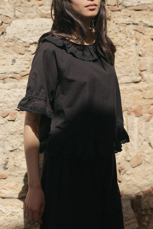 Model wearing the Arlette Top in Noir by Gillian Stevens, front view showing lace collar and ruffle cuffs