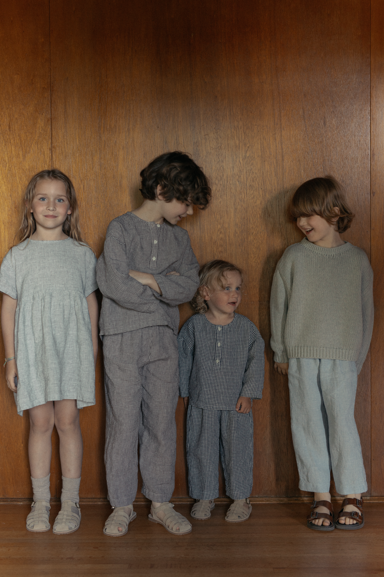 Child wearing the Bertie Pant in Espresso Gingham by Gillian Stevens, front view styled with matching top