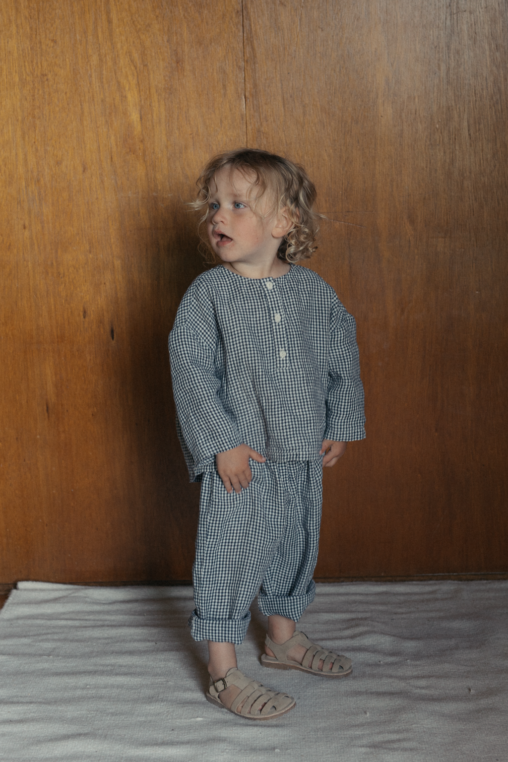 Toddler wearing the Bertie Top in Marine Gingham by Gillian Stevens, full-length front view styled with matching pants