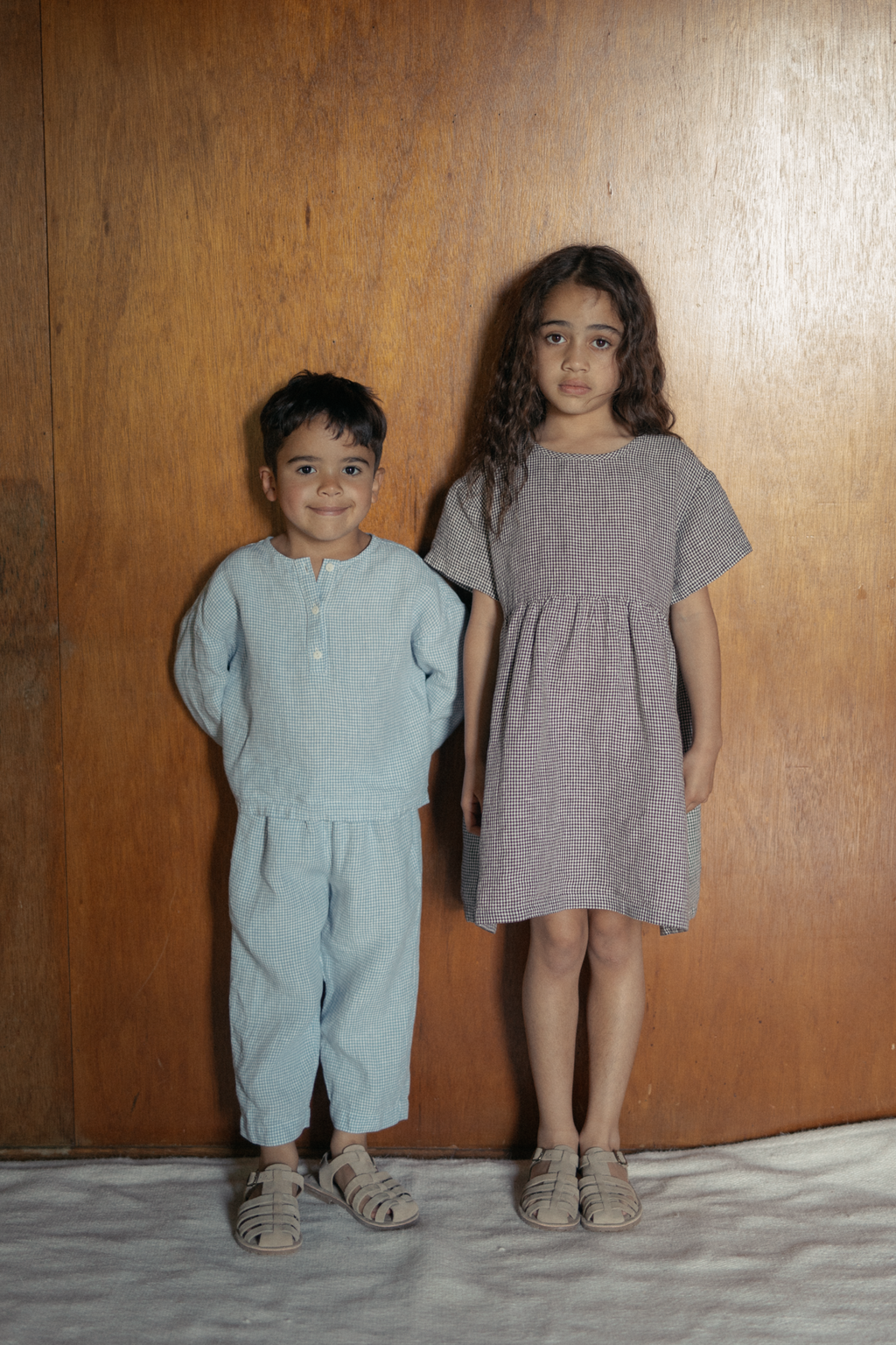 Child wearing the Mini Aya in Espresso Gingham by Gillian Stevens