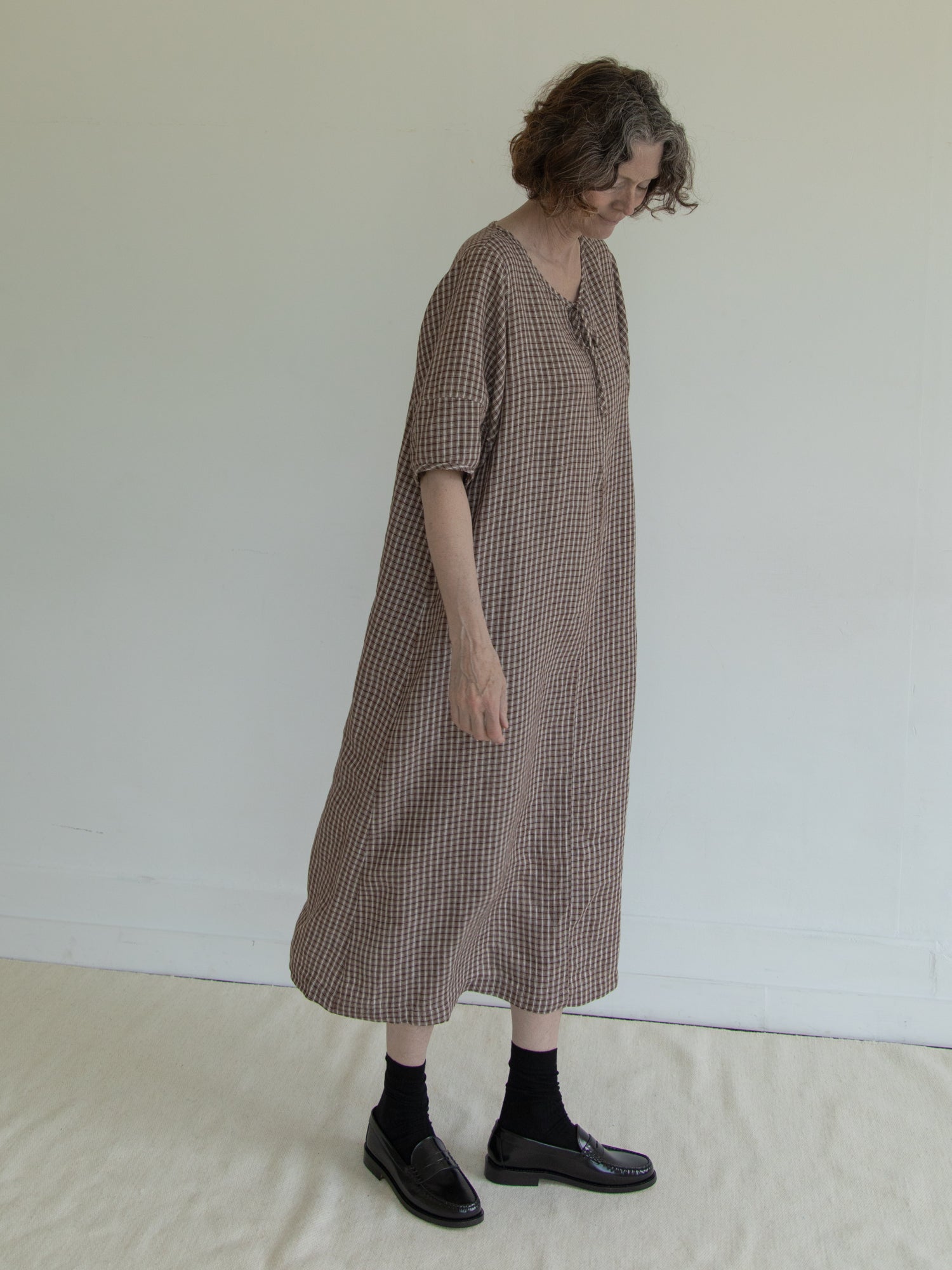 Model wearing the Blair Dress in Chocolate Plaid by Gillian Stevens, side view showing relaxed silhouette